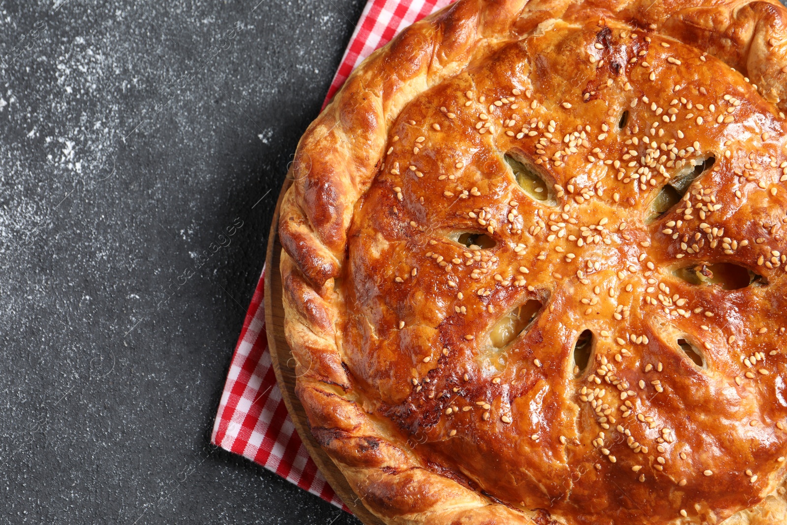 Photo of Tasty homemade pie on grey table, top view. Space for text