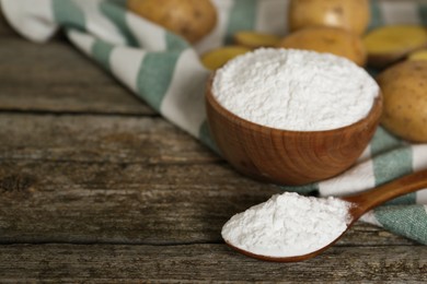 Photo of Starch and fresh raw potatoes on wooden table. Space for text