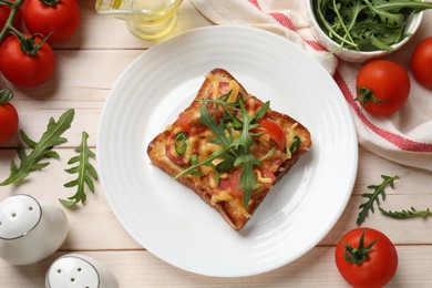 Tasty pizza toasts and ingredients on light wooden table, flat lay