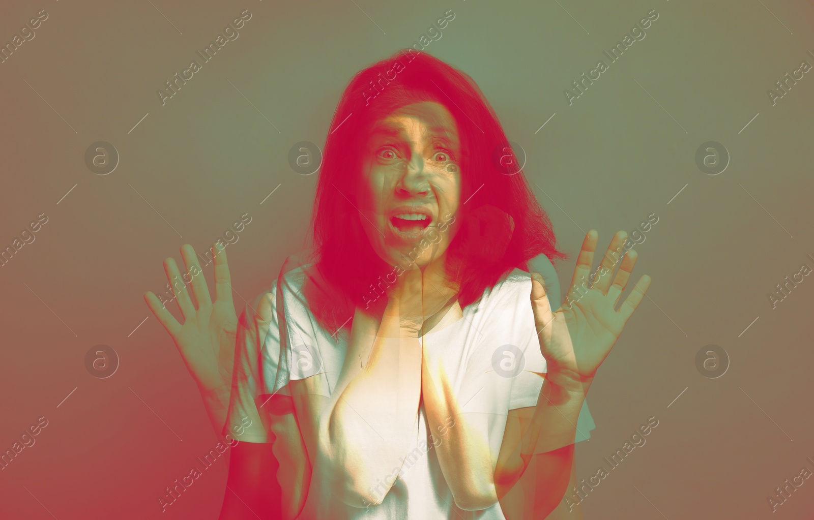 Image of Paranoia. Multiple exposure with photos of emotional woman, color toned