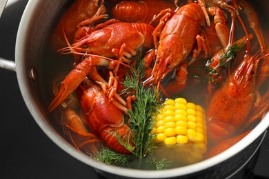 Photo of Fresh delicious crayfishes in pot, closeup view