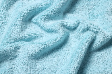 Texture of soft light blue crumpled fabric as background, closeup
