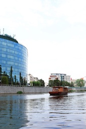 Photo of Building with tinted windows near river. Modern architectural design