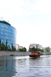 Building with tinted windows near river. Modern architectural design