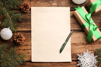 Flat lay composition with blank sheet of paper on wooden table, space for text. Writing letter to Santa