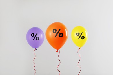 Discount offer. Balloons with percent sign on white background