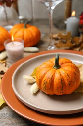 Photo of Beautiful autumn place setting and decor on wooden table, closeup