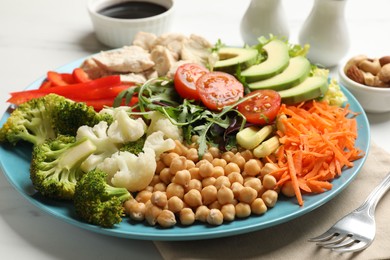 Balanced diet and healthy foods. Plate with different delicious products on white marble table, closeup