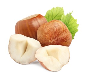 Image of Tasty hazelnuts and green leaves on white background