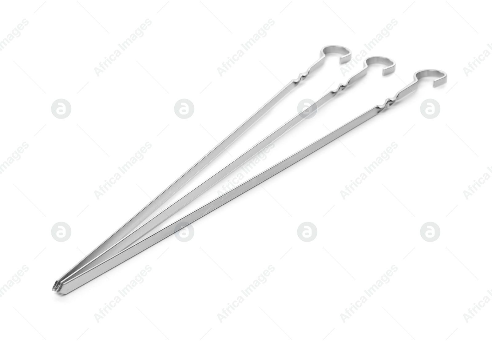 Photo of Metal skewers on white background. Barbecue utensil