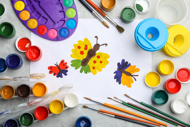 Photo of Flat lay composition with child's painting of butterflies on marble table