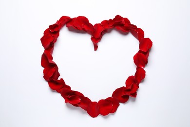 Photo of Heart shaped frame of beautiful red rose petals on white background, top view