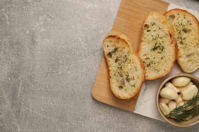 Photo of Tasty baguette with garlic and dill on light grey table, top view. Space for text