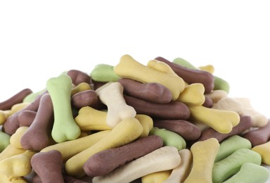 Photo of Pile of different bone shaped dog cookies on white background, closeup