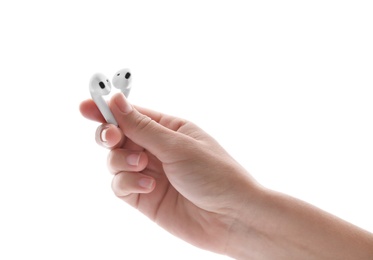 Photo of Woman holding modern wireless earphones on white background, closeup