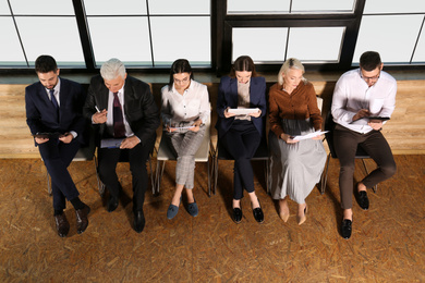 Photo of People waiting for job interview in office hall, above view