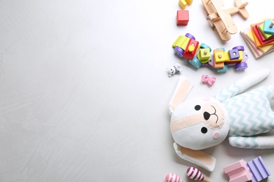 Photo of Different toys on light background, flat lay. Space for text