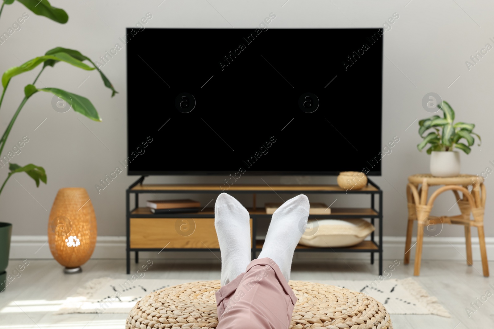 Photo of Woman having rest at stylish TV set, closeup