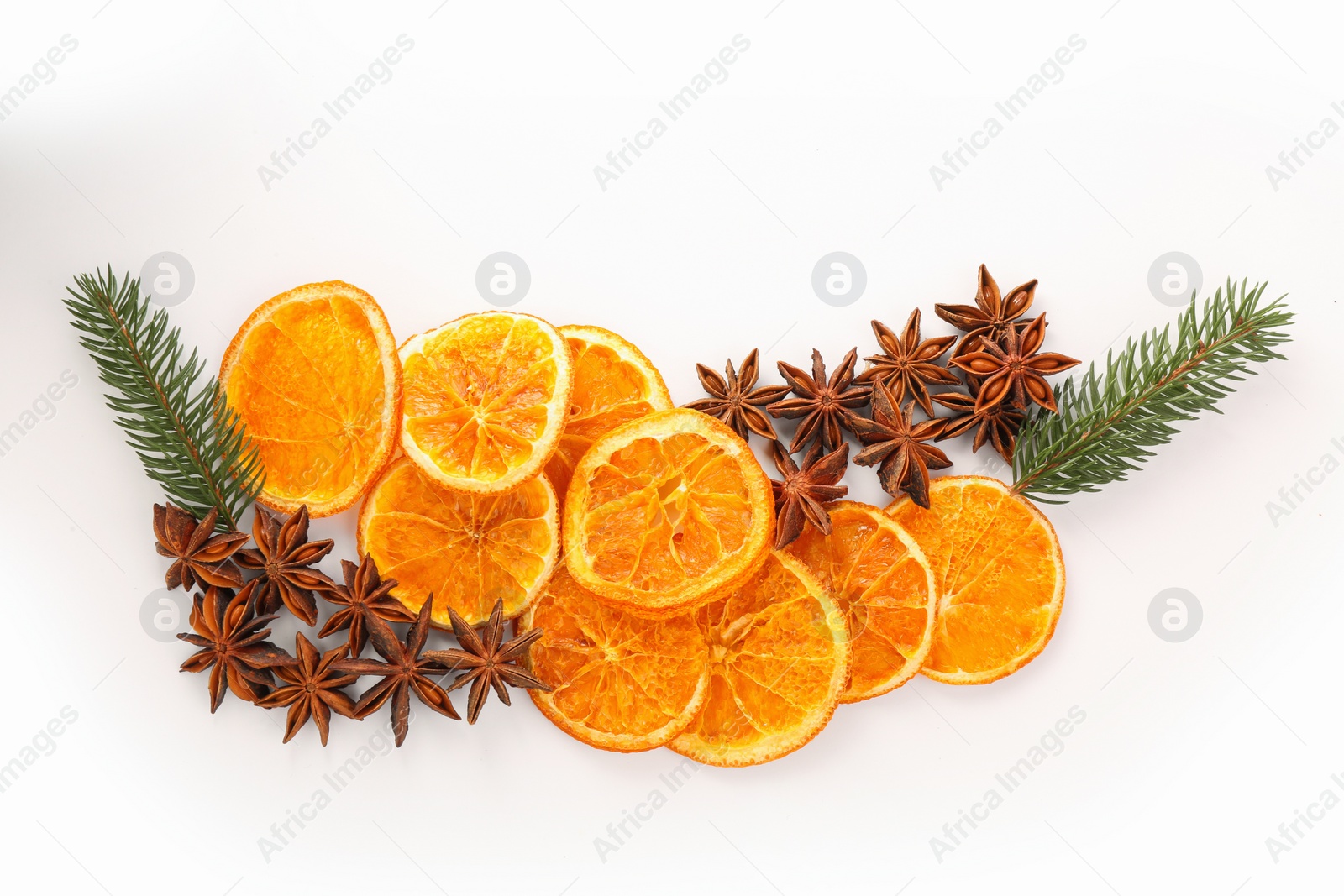 Photo of Dry orange slices, fir branches and anise stars on white background, flat lay