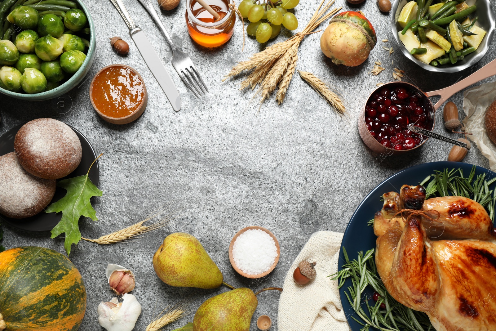 Photo of Frame made of delicious turkey, autumn vegetables and fruits on grey background, flat lay with space for text. Happy Thanksgiving day