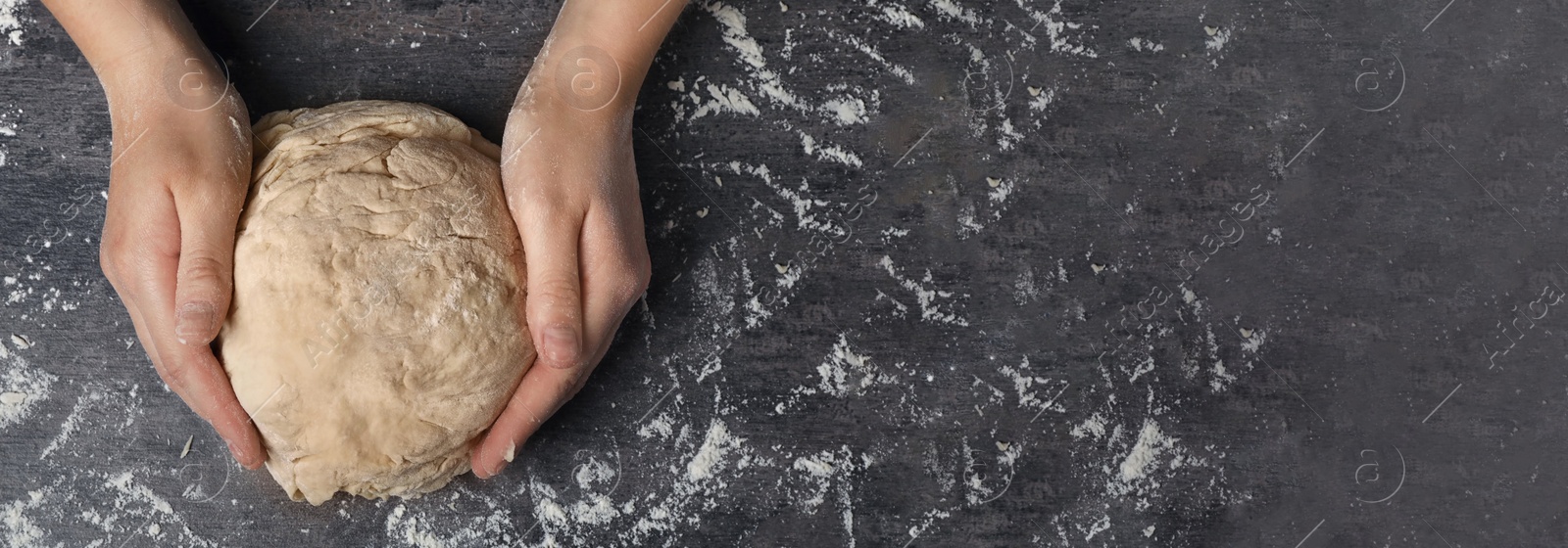 Image of Woman kneading dough at table, top view. Banner design with space for text