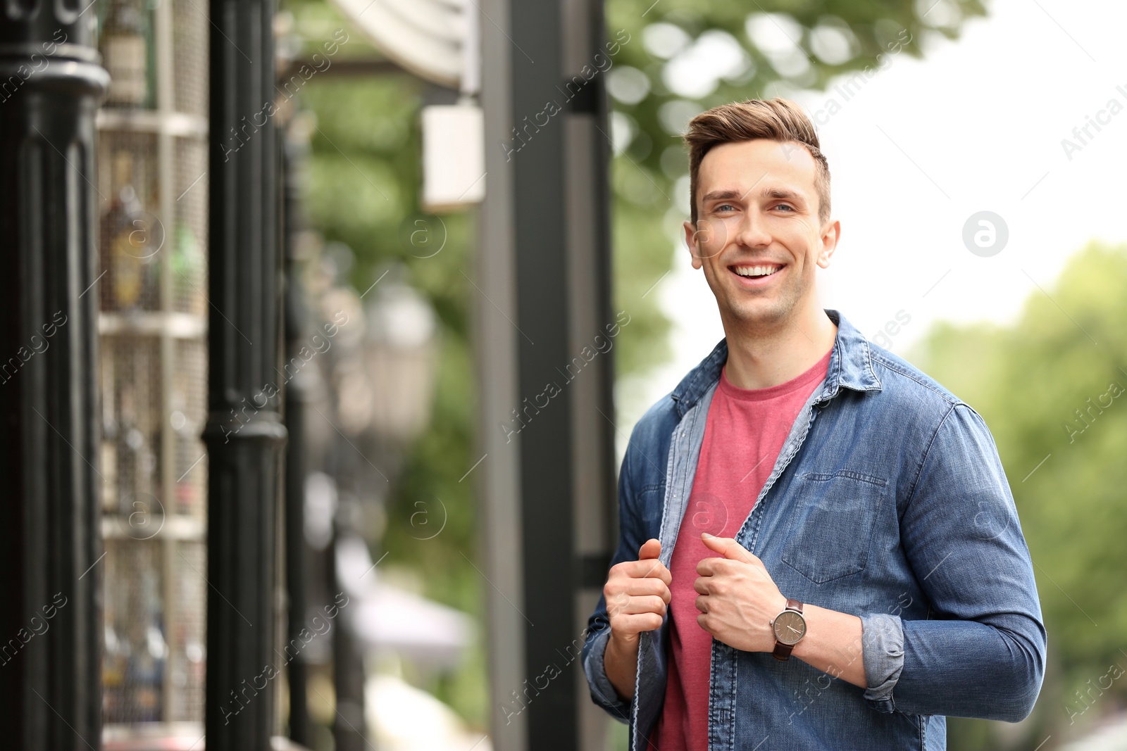 Photo of Portrait of attractive young man in stylish outfit outdoors