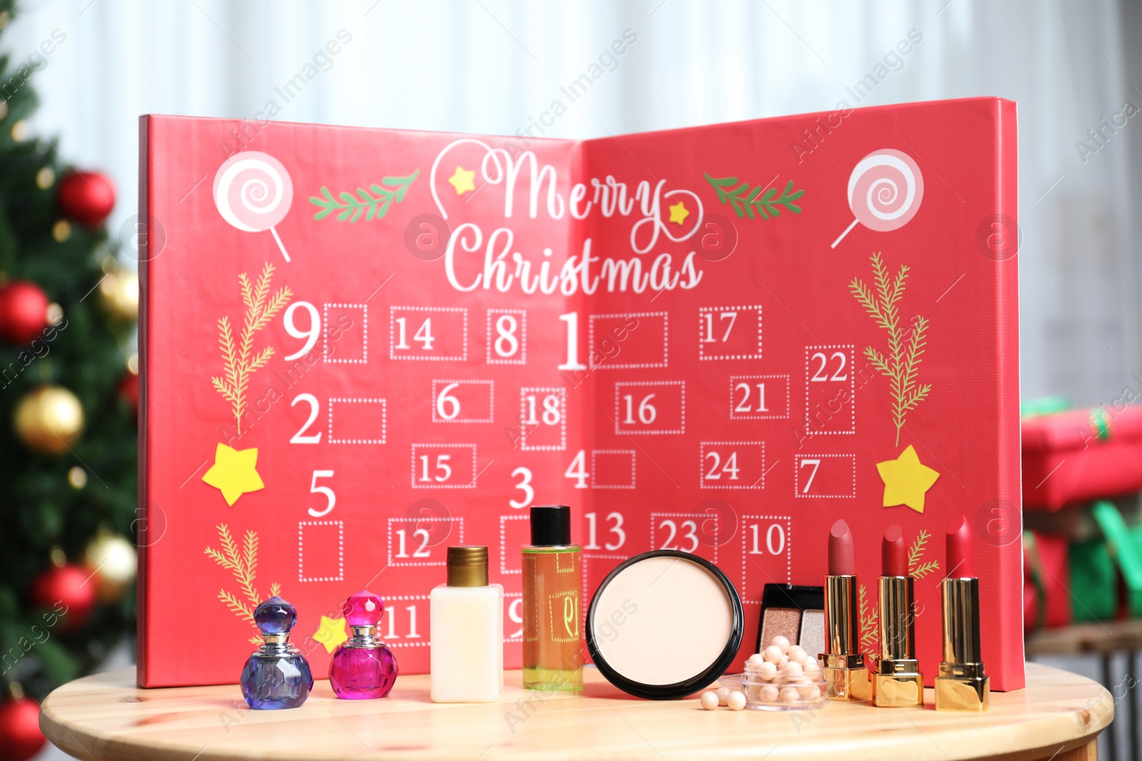 Christmas advent calendar with perfumes, skin care and decorative cosmetics on table Photo of Christmas advent calendar with perfumes, skin care and decorative cosmetics on table