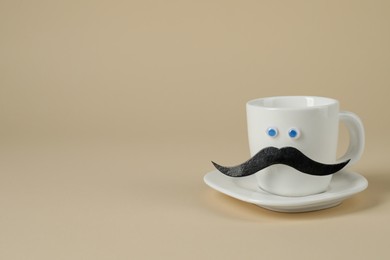 Photo of Man's face made of fake mustache, cup and eyes on beige background, space for text