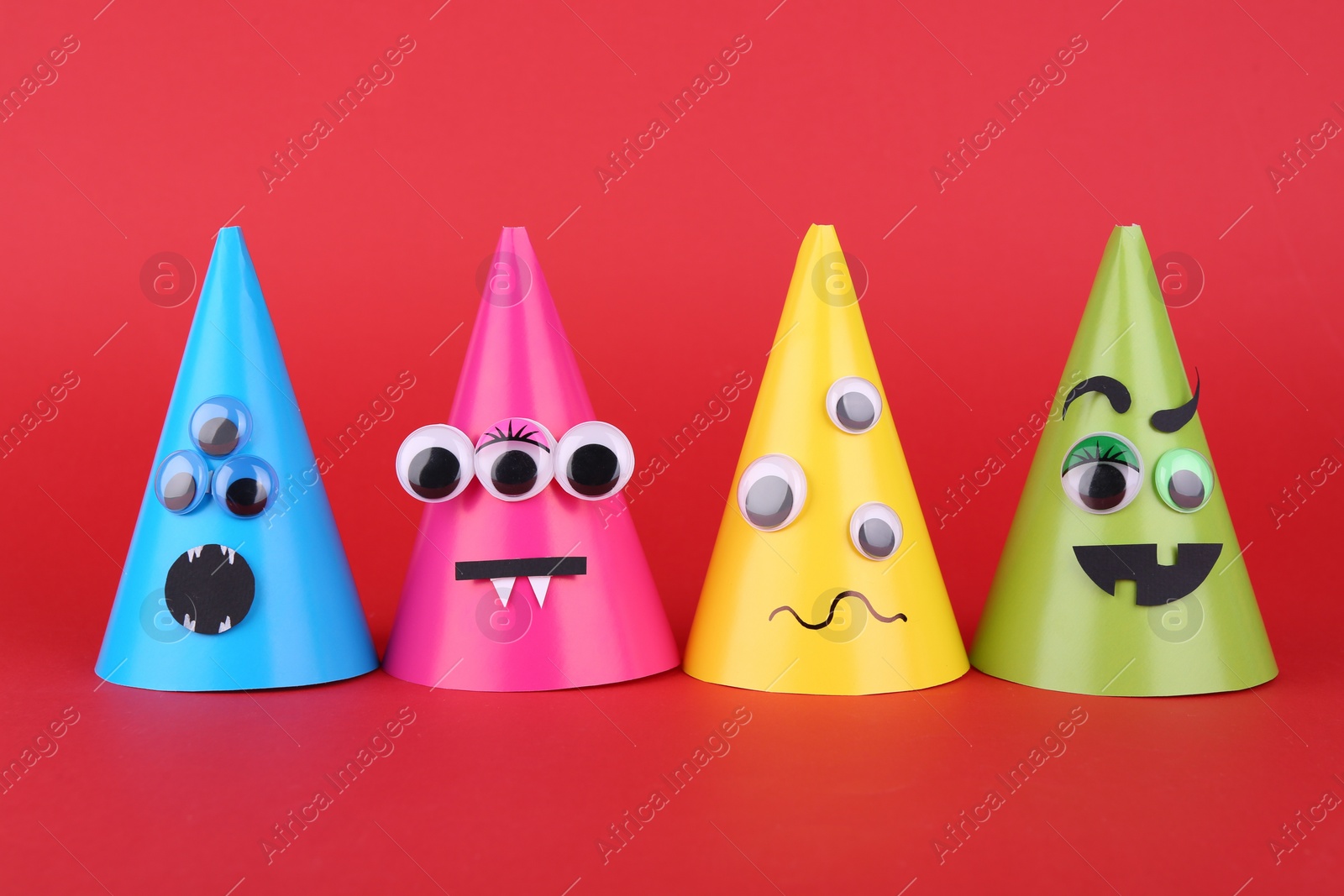 Photo of Spooky paper Halloween monsters on red background