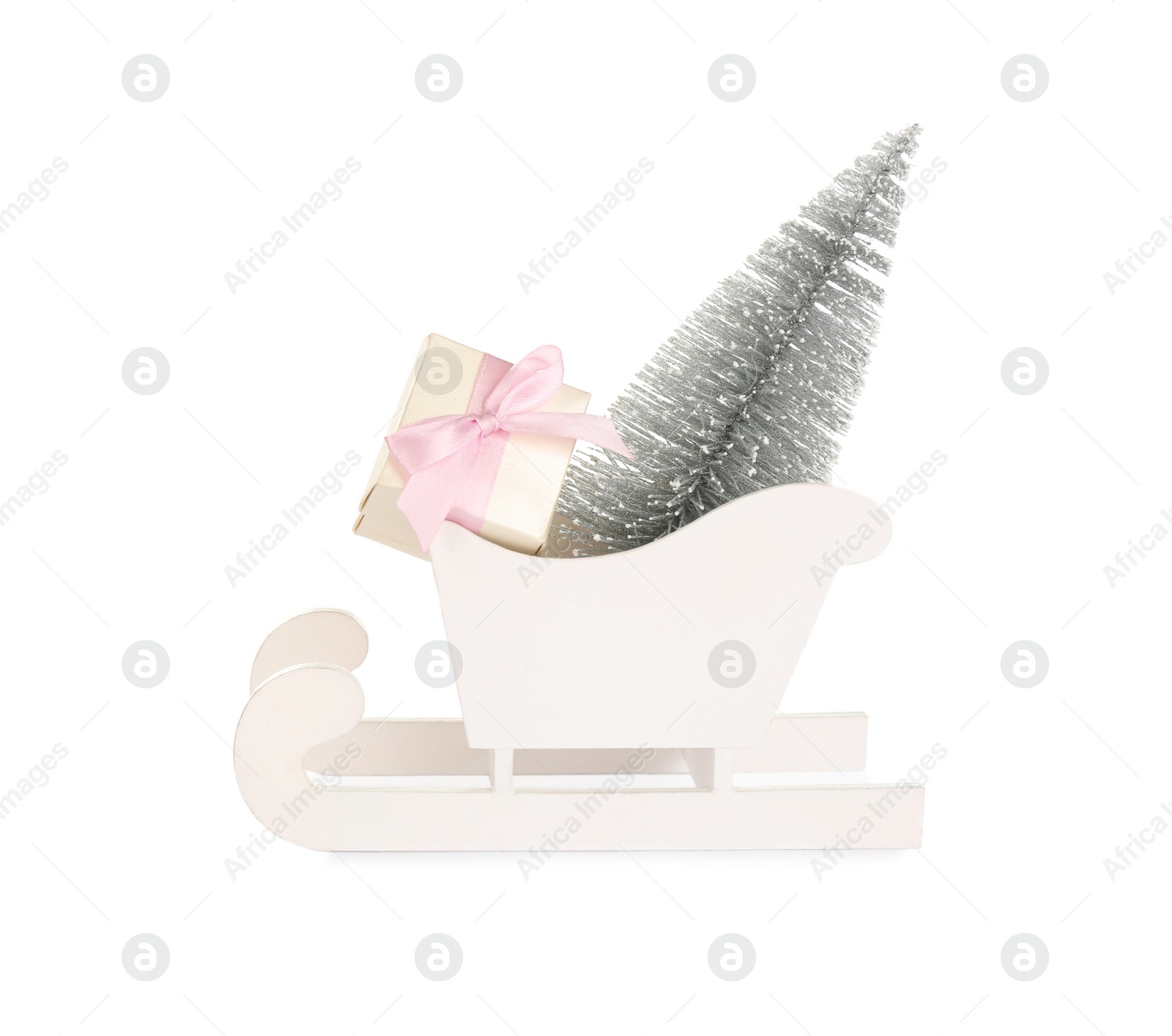Photo of Wooden sleigh with decorative fir tree and present on white background. Christmas holidays