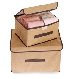 Photo of Textile storage cases with folded clothes on white background