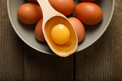 Raw chicken eggs on wooden table, top view