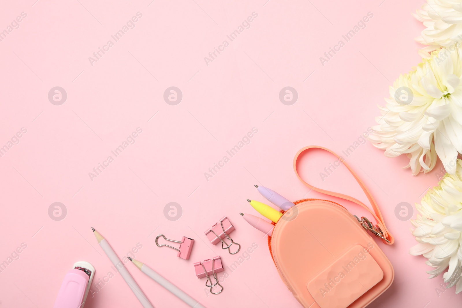 Photo of Flat lay composition with flowers and stationery on pink background, space for text. Teacher's day
