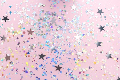 Photo of Shiny glitter on light pink background, flat lay