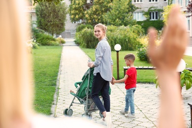 Photo of Mother leaving children with teen nanny in park