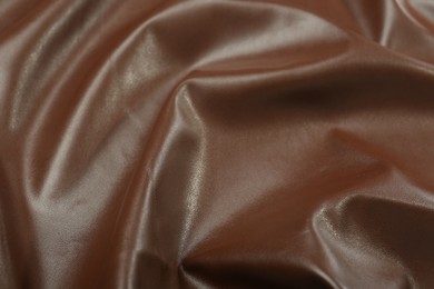 Brown natural leather as background, closeup view