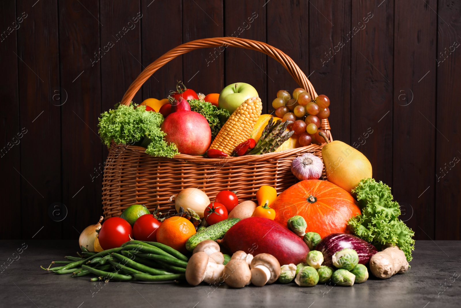 Photo of Assortment of fresh organic fruits and vegetables on grey table