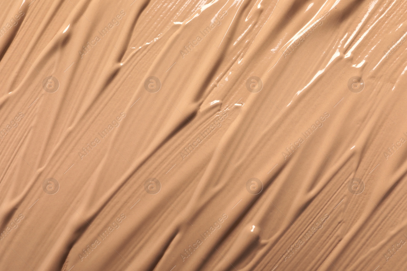 Photo of Texture of skin foundation as background, closeup