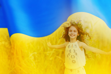 Double exposure of adoracble little girl with flower wreath running outdoors and Ukrainian flag 