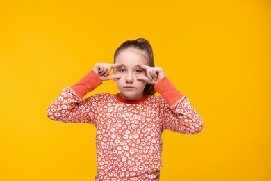 Photo of Sleepy girl on orange background. Insomnia problem