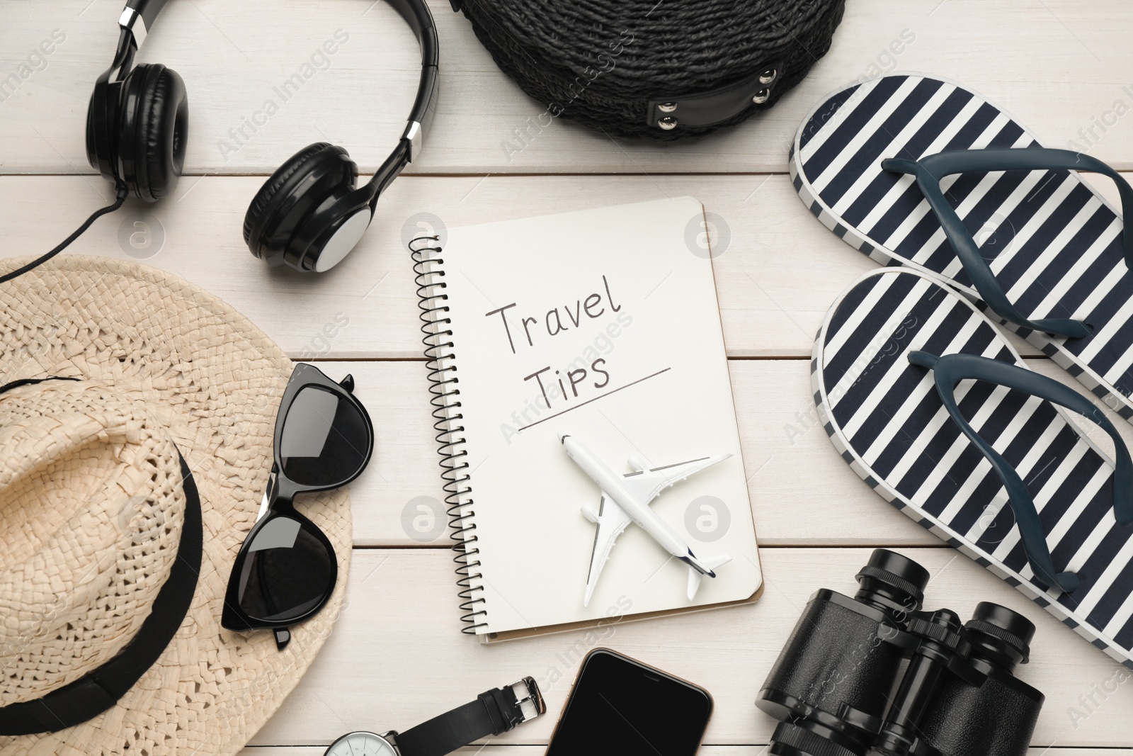 Photo of Flat lay composition with notebook on white wooden table. Travel Tips