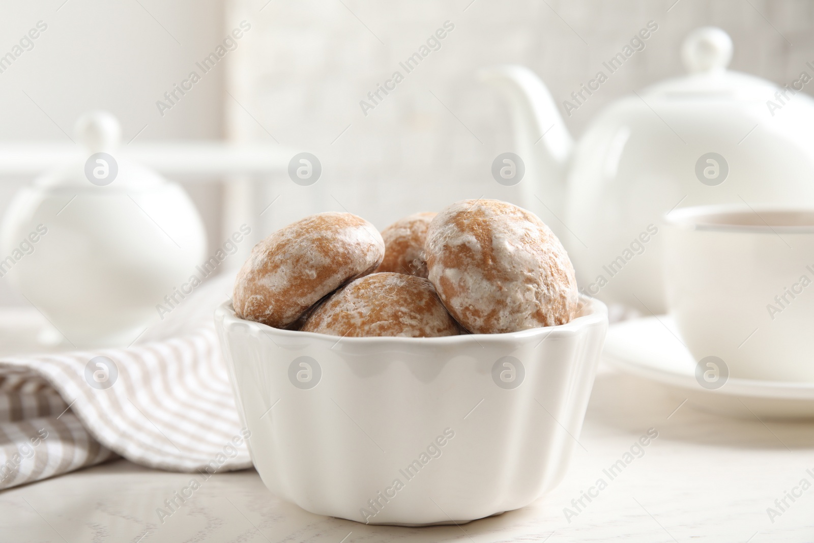 Photo of Tasty homemade gingerbread cookies in bowl on white table
