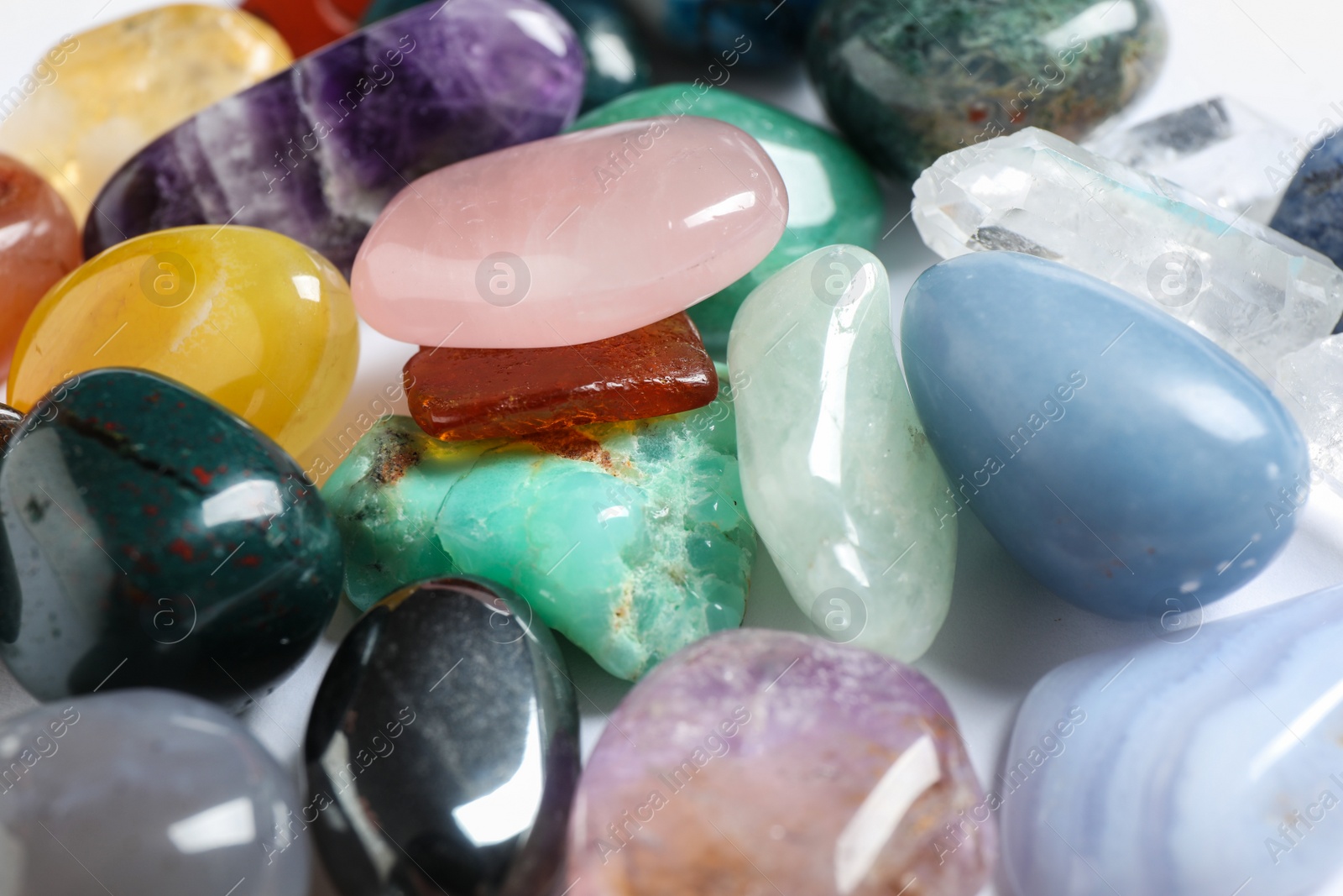 Photo of Different beautiful gemstones on white background, closeup