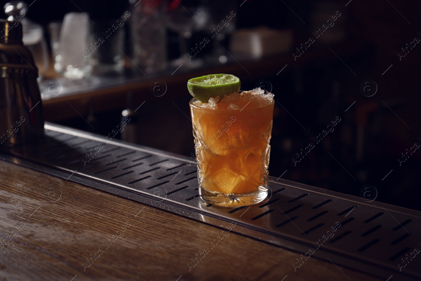 Photo of Glass of fresh alcoholic cocktail on bar counter