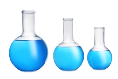 Photo of Florence flasks with blue liquid on white background. Laboratory glassware