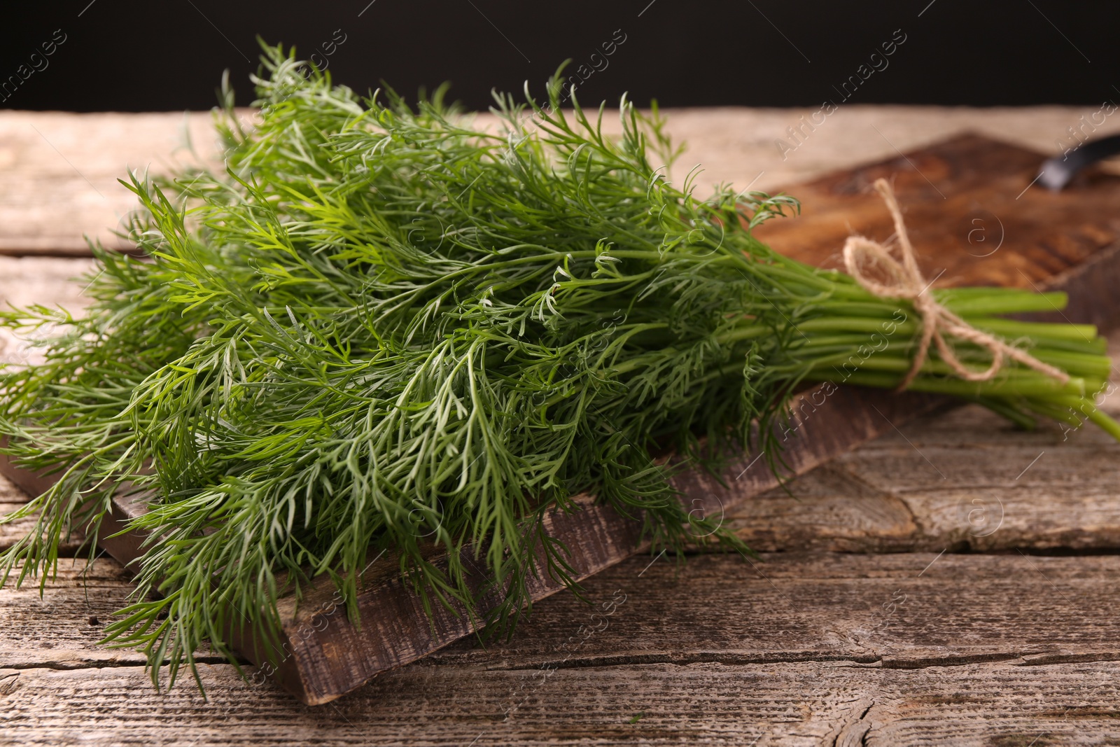 Photo of Bunch of fresh dill on wooden table, closeup