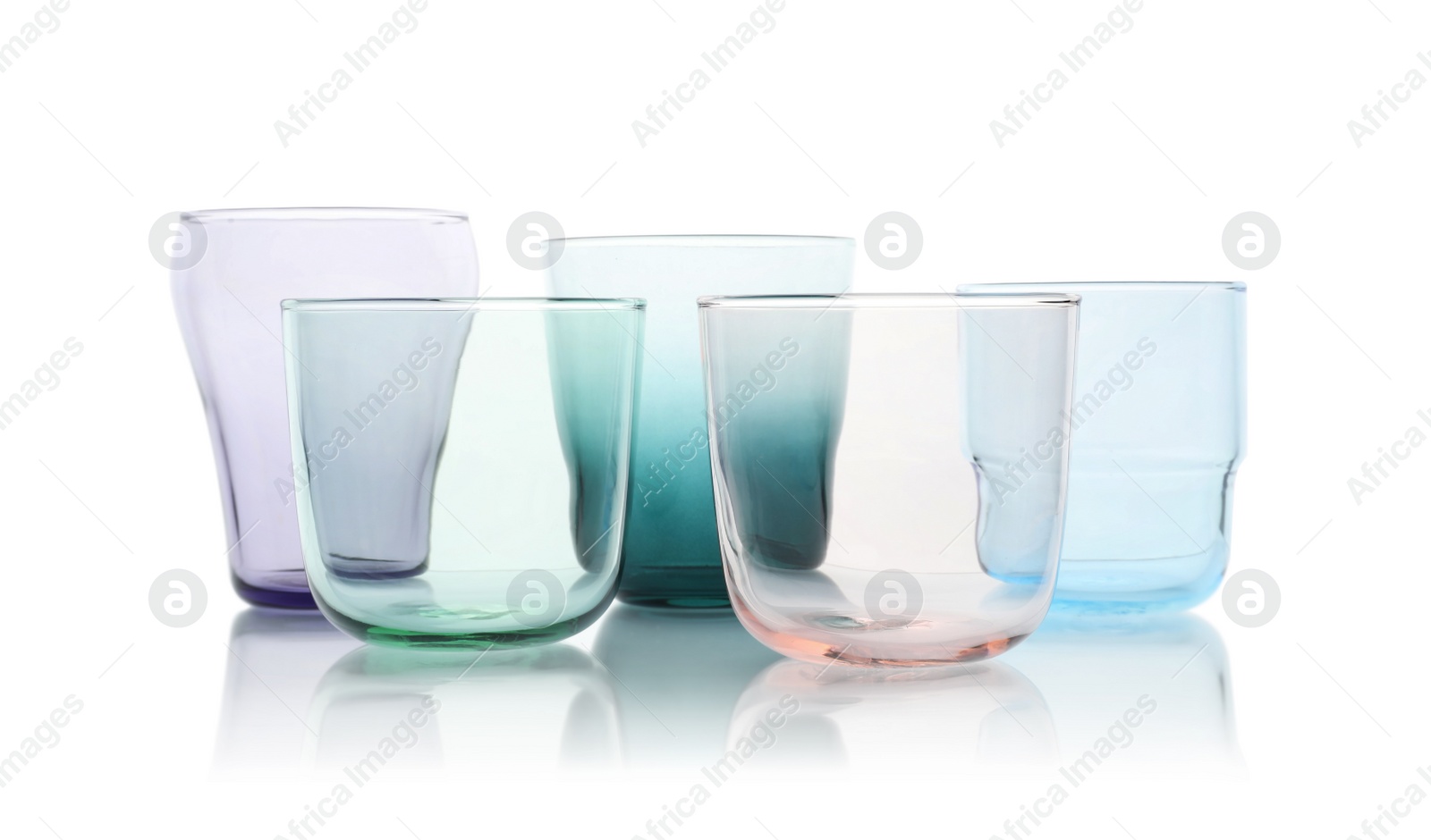 Photo of Set of colorful empty glasses on white background