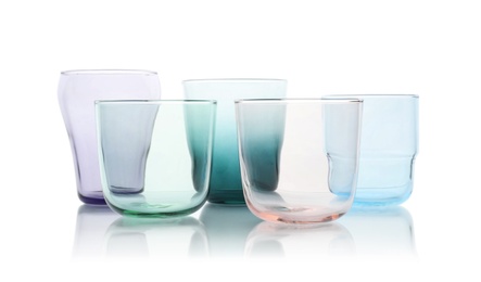 Set of colorful empty glasses on white background