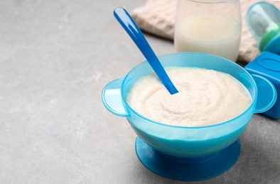 Photo of Healthy baby food on grey table, space for text