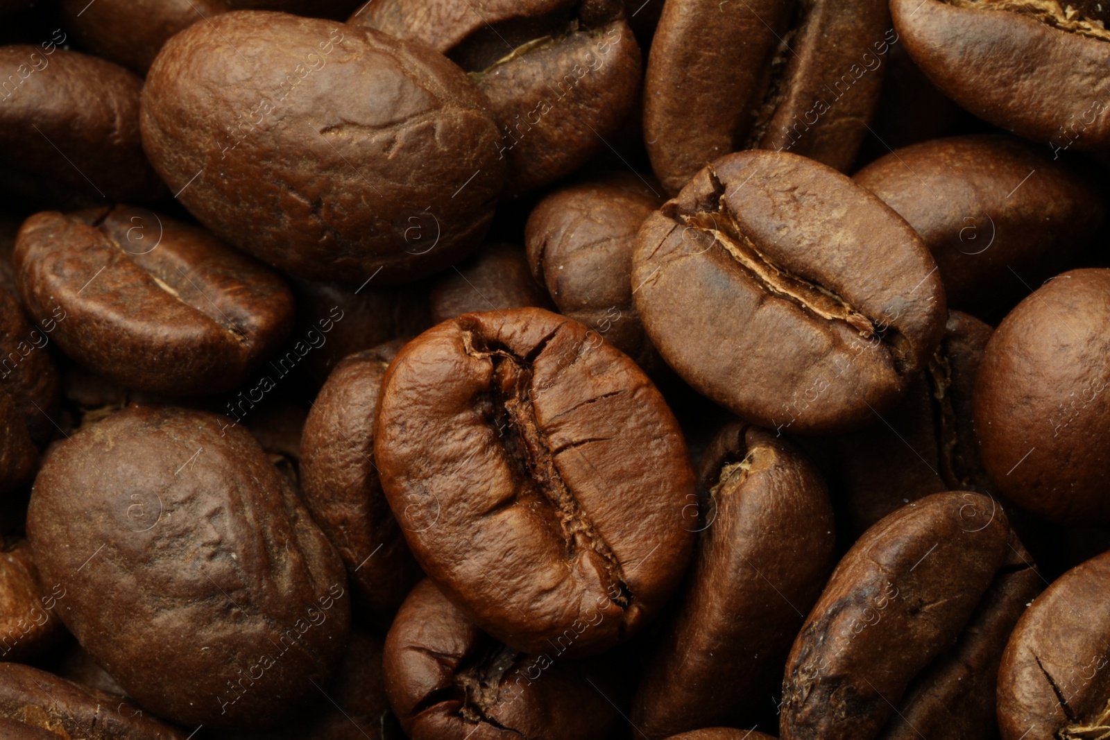 Photo of Pile of roasted coffee beans as background, closeup